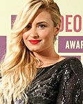 Singer Demi Lovato holds award for 'Best Video With A Message' at the 2012 MTV Video Music Awards in Los Angeles