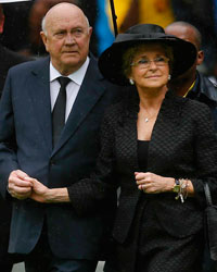 Former South African President Frederik Willem de Klerk (C) arrives for the memorial service for late South African President Nelson Mandela at the FNB soccer stadium in Johannesburg