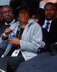 Former South African President Nelson Mandela ex-wife Winnie Mandela (L), wife Graca Machael (R) and other family members attend the official memorial service for Nelson Mandela at the First National Bank soccer stadium