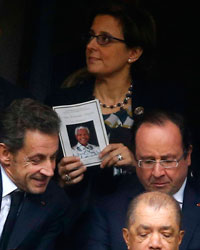 Former French President Nicolas Sarkozy (center row L) and his successor Francois Hollande (center row R) attend the memorial service for late South African President Nelson Mandela at the First National Bank soccer stadium