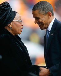 U.S. President Barack Obama (2nd R) pays his respect to former South African President Nelson Mandela's widow Graca Machel (2nd L) after his speech at the memorial service for late South African President Nelson Mandela at the First National Bank stadium