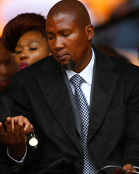 Mandla Mandela (C), eldest grandson of former South African President Nelson Mandela, attends the official memorial service for Nelson Mandela at the First National Bank stadium