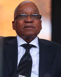 South African President Jacob Zuma holds the official program for the memorial service for late South African President Nelson Mandela at the FNB soccer stadium in Johannesburg