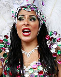 Performers shelter from the rain at the start of Notting Hill Carnival in west London