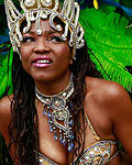 Performers shelter from the rain at the start of Notting Hill Carnival in west London