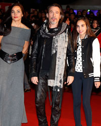 French singer Florent Pagny (C) arrives with his wife Azucena and daughter Ael at the Cannes festival palace to attend the NRJ Music Awards in Cannes