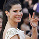 Sandra Bullock gestures as she arrives at the 84th Academy Awards in Hollywood