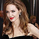 Brad Pitt and his partner actress Angelina Jolie walk the red carpet at the 84th Academy Awards in Hollywood