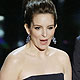 Presenters Tina Fey and Bradley Cooper stand on stage at the 84th Academy Awards in Hollywood