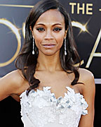 Actress Zoe Saldana poses on the red carpet in an Alexis Mabille Couture dress as she arrives at the 85th Academy Awards in Hollywood, California