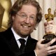 Andrew Stanton holds up his Oscar for best animated feature for Wall-E at the Academy Awards in Hollywood