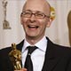 Chris Dickens holds his Oscar for film editing at the Academy Awards in Hollywood