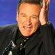 Robin Williams holds his award for funniest male actor at the 33rd annual People`s Choice Awards