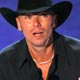 Kenny Chesney holds his award for favorite male singer at the 33rd annual People`s Choice Awards in Los Angeles