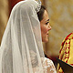 Britain's Prince William, and Kate Middleton stand before the Archbishop of Canterbury, Rowan Williams, in Westminster Abbey, in central London