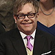 British Singer Elton John (C) and his partner David Furnish (L) , attend the wedding of Prince William, and Catherine, Duchess of Cambridge in Westminster Abbey, in central London