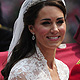 Britain's Catherine Duchess of Cambridge travels to Buckingham Palace in the 1902 State Landau along Procession Route after her wedding to Britain's Prince William in Westminster Abbey in London