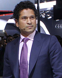 Sachin Tendulkar poses with the BMW i8 Hybrid car at the Auto Expo 2014