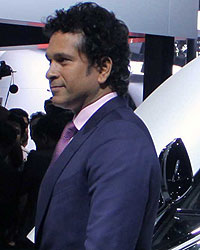 Sachin Tendulkar poses with the BMW i8 Hybrid car at the Auto Expo 2014