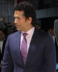 Sachin Tendulkar poses with the BMW i8 Hybrid car at the Auto Expo 2014