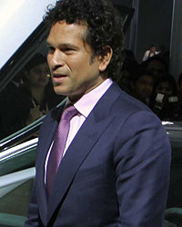 Sachin Tendulkar poses with the BMW i8 Hybrid car at the Auto Expo 2014