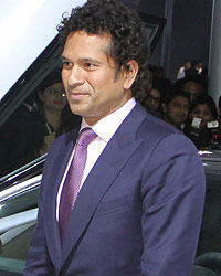 Sachin Tendulkar poses with the BMW i8 Hybrid car at the Auto Expo 2014