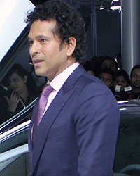 Sachin Tendulkar poses with the BMW i8 Hybrid car at the Auto Expo 2014