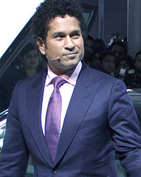 Sachin Tendulkar poses with the BMW i8 Hybrid car at the Auto Expo 2014