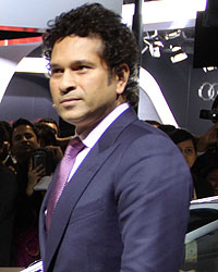 Sachin Tendulkar poses with the BMW i8 Hybrid car at the Auto Expo 2014