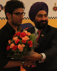 JD Ghai presenting a bouquet to Paras Ghai