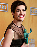 Actress Anne Hathaway, from the film 'Les Miserables', holds her award for best female actor in a supporting role backstage at the 19th annual Screen Actors Guild Awards