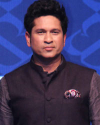 Former cricket player Sachin Tendulkar walks the ramp during the launch of the flagship True Blue store