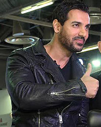 John Abraham poses on a Yamaha R1 motorcycle, during the Auto Expo 2014