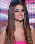 U.S. singer Selena Gomez and actress Zooey Deschanel speak on stage at the 2012 Teen Choice Awards at the Gibson Amphitheatre in Universal City