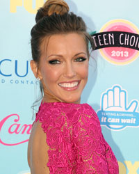 Actress Katie Cassidy poses as she arrives at the Teen Choice Awards at the Gibson amphitheatre in Universal City, California