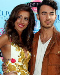 Singer Kevin Jonas and wife Danielle Deleasa pose as they arrive at the Teen Choice Awards at the Gibson amphitheatre in Universal City, California