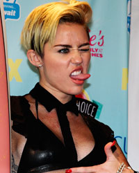 Actress and singer Miley Cyrus poses for photographers after being named this years 'Candies' Choice Style Icon at the Teen Choice Awards at the Gibson amphitheatre in Universal City, California