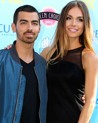 Singer Joe Jonas and girlfriend Blanda Eggenschwiler pose as they arrive at the Teen Choice Awards at the Gibson amphitheatre in Universal City, California