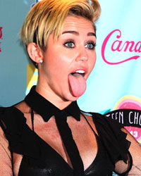 Actress and singer Miley Cyrus poses for photographers after being named this years' Candies' Choice Style Icon at the Teen Choice Awards at the Gibson amphitheatre in Universal City, California