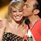 Rob Schneider kisses show co-host Hilary Duff at the 2005 Teen Choice Awards at the Gibson Amphitheater in Universal City, California.