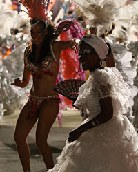 Members of a comparsa, an Uruguayan carnival band, perform during the second night of the Llamadas parade in Montevideo