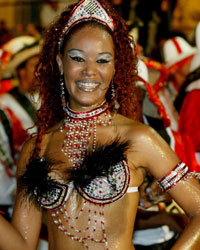 Members of a 'comparsa' play and dance candombe during the 'llamadas' parade in Montevideo, Uruguay