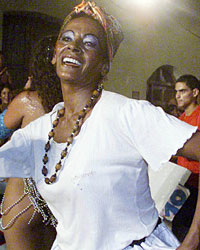 Uruguayan descendants of African immigrants dance in colonial custumes during the 'llamadas' parade, a traditional festival dating back to the Spanish domination of Latin America, in Montevideo