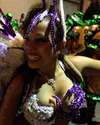 Members of a comparsa, an Uruguayan carnival band, perform during the second night of the Llamadas parade in Montevideo