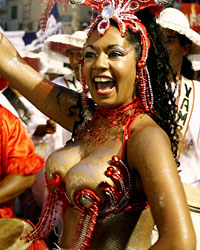 Members of a 'comparsa', a Uruguayan carnival group, dance and play candombe during the 'llamadas' parade in Montevideo