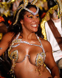 A dancer performs to candombe music played by a comparsa, an Uruguayan carnival band, during a Llamadas parade in Montevideo