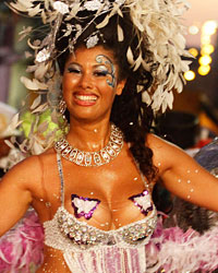 A dancer performs to candombe music played by a comparsa, an Uruguayan carnival band, during a Llamadas parade in Montevideo