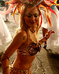 Members of a 'comparsa', a Uruguayan carnival group, dance and play candombe during the 'llamadas' parade in Montevideo