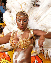 A dancer performs to candombe music played by a comparsa, an Uruguayan carnival band, during the second night of the Llamadas parade in Montevideo