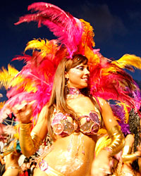 Dancers perform to candombe music played by a comparsa, an Uruguayan carnival band, during the second night of the Llamadas parade in Montevideo